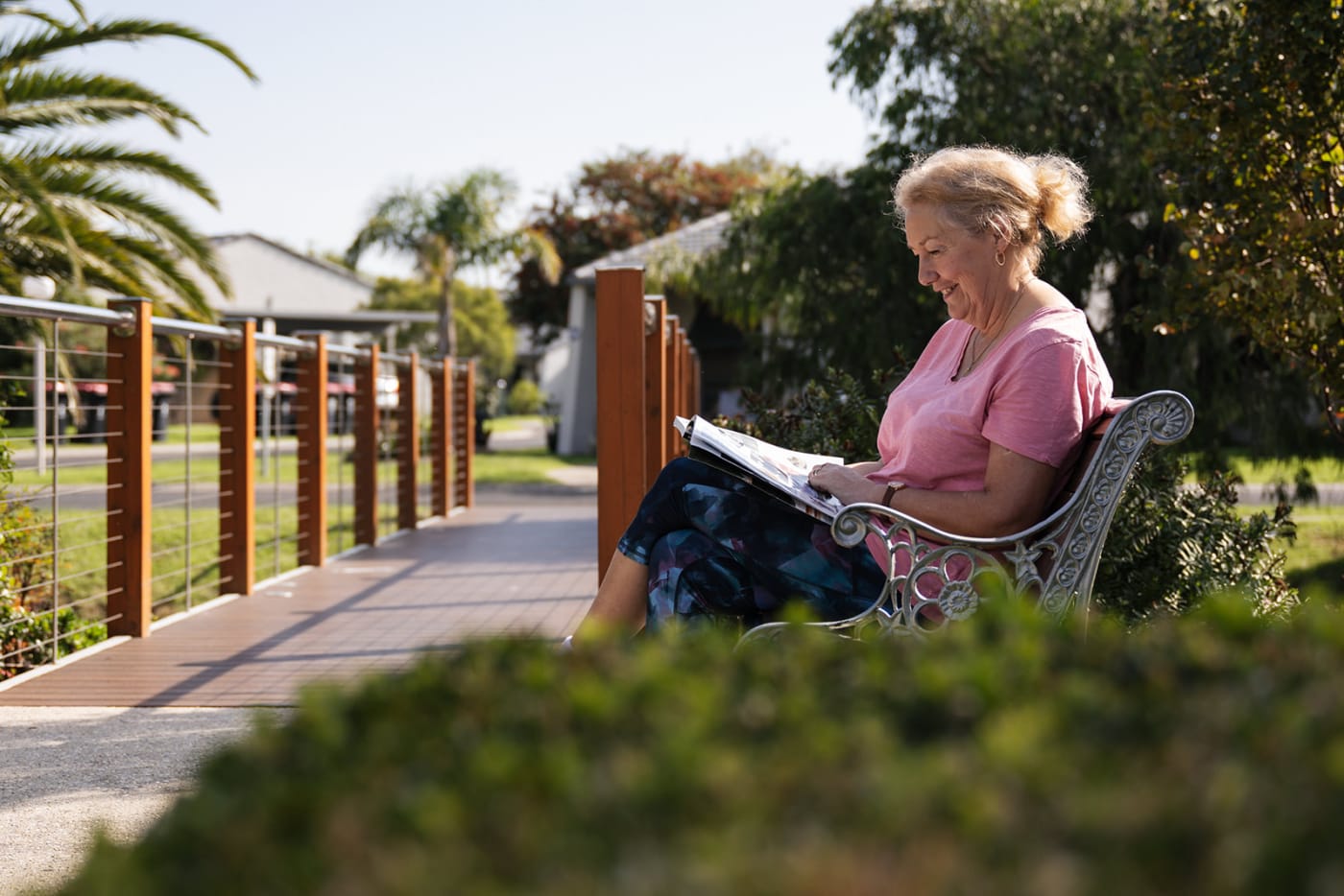 lady outside sitting on a bench