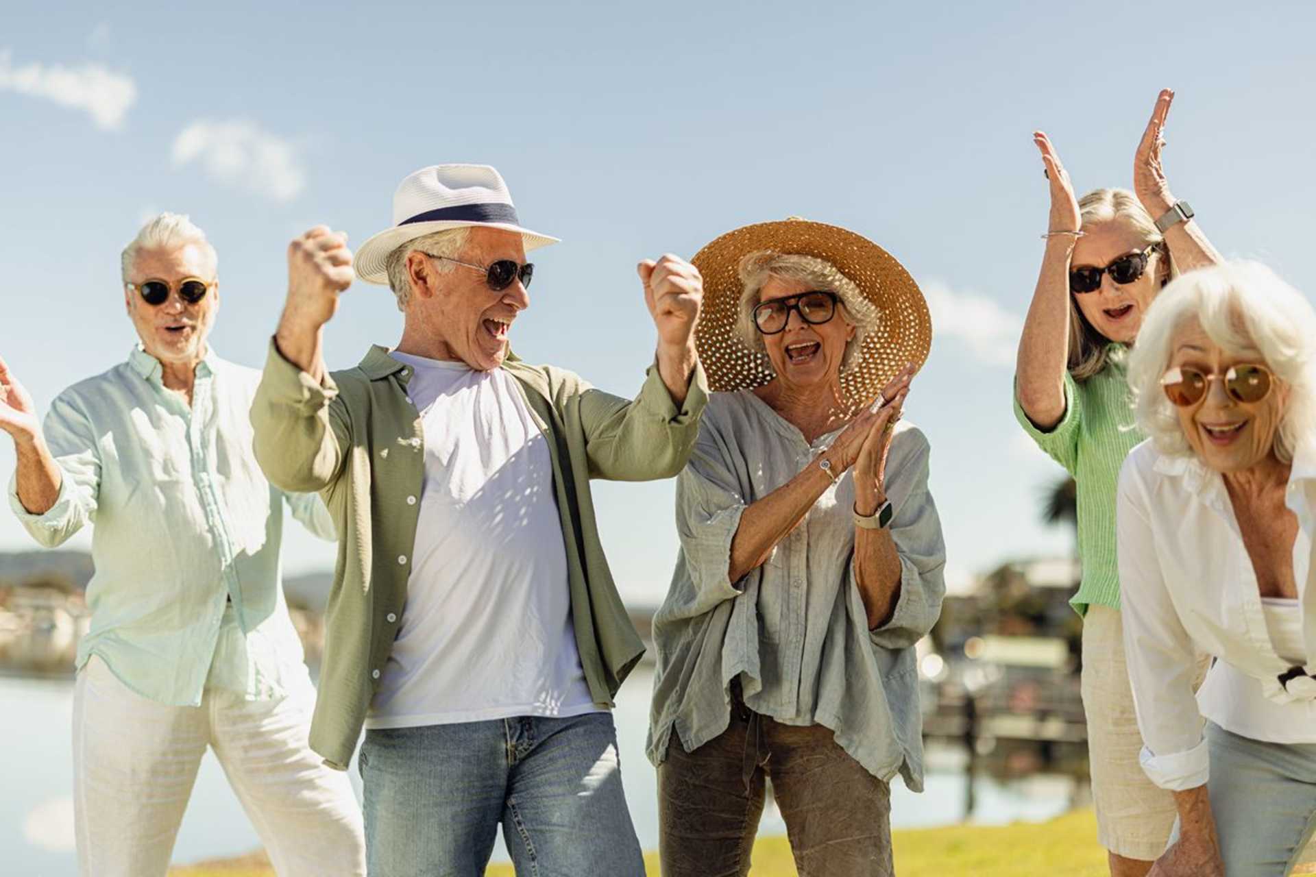 Group of retirees playing finska, close up celebrating in sunshine